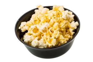 Popcorn in a bowl on white background photo
