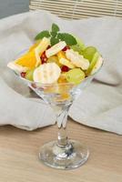 Fruit salad on wooden background photo