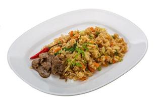 Fried rice with beef on the plate and white background photo