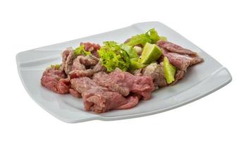 Beef carpaccio on the plate and white background photo