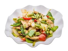 Pork with vegetables on the plate and white background photo