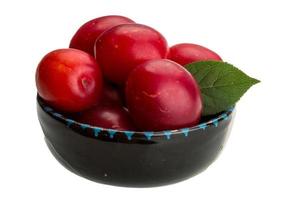 Damson plum in a bowl on white background photo