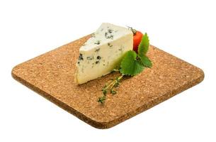 Blue cheese on wooden board and white background photo