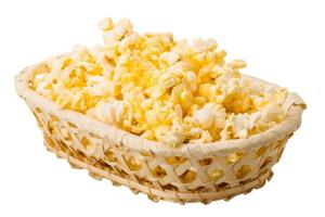 Popcorn in a basket on white background photo