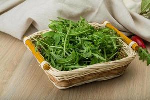 Ruccola on wooden background photo