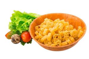 Raw pasta in a bowl on white background photo