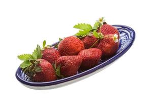 Ripe strawberry in a bowl on white background photo