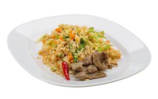 Fried rice with beef on the plate and white background photo