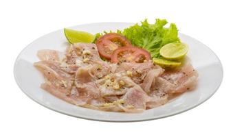 Swordfish carpaccio on the plate and white background photo