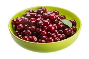 Cherry in a bowl on white background photo