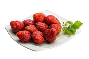 Ripe strawberry on the plate and white background photo