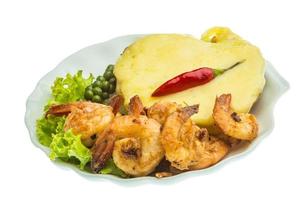 Garlic shrimps with potato on the plate and white background photo