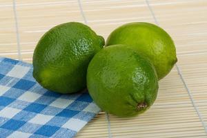 Lime on wooden background photo