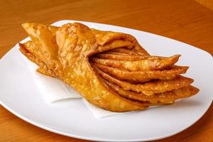 Baklava on the plate and wooden background photo