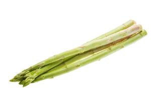 Raw asparagus on white background photo