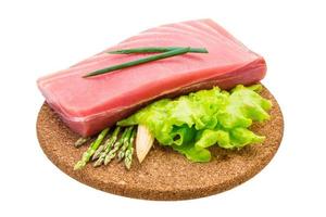 Tuna raw steak on wooden board and white background photo