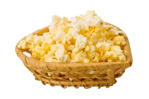 Popcorn in a basket on white background photo
