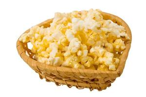 Popcorn in a basket on white background photo