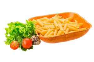 Raw pasta in a bowl on white background photo