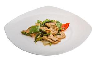 Pork with vegetables on the plate and white background photo