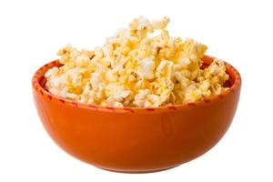 Popcorn in a bowl on white background photo