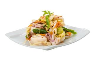 Asian seafood salad on the plate and white background photo