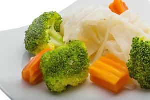 Boiled cabbage and broccoli on the plate and white background photo