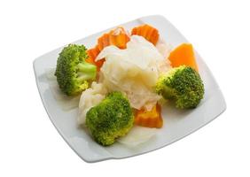 Boiled cabbage and broccoli on the plate and white background photo