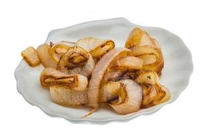 Fried onion on the plate and white background photo