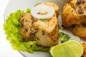 Chicken Tikka on the plate and white background photo