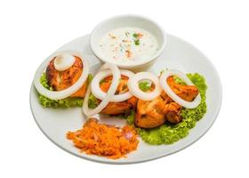 Chicken Tikka on the plate and white background photo