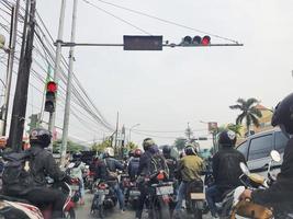 West Java, Indonesia on July 2022. Many motorcyclists are stopping at traffic lights photo