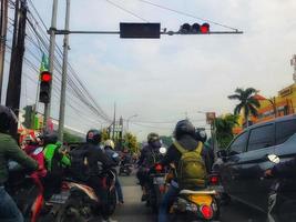 West Java, Indonesia on July 2022. Many motorcyclists are stopping at traffic lights photo