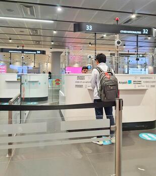 Istanbul, Turkey on July 2022. Several tourists are queuing for passport checking at the passport control counter, both local and international tourists. photo