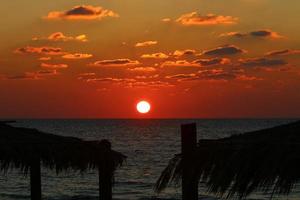 The sun sets below the horizon on the Mediterranean Sea in northern Israel. photo