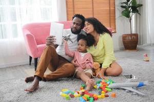 Joyful multiethnic family and their leisure at home photo