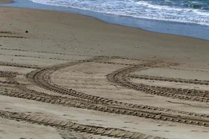 Footprints in the sand on the shores of the Mediterranean Sea. photo
