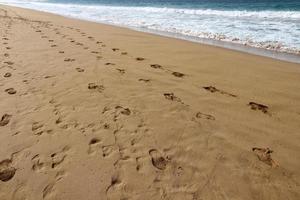 Footprints in the sand on the shores of the Mediterranean Sea. photo