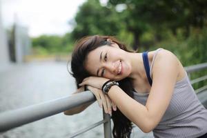 Young attractive woman doing stretching yoga exercise in the park. photo