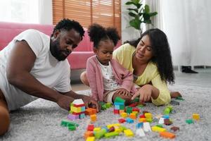 Happy african family having playful time at home,  Family love, Parents and toddler indoor photo