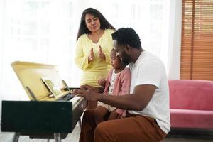 feliz familia africana que se divierte en casa, amor familiar, padres y niños pequeños en el interior foto