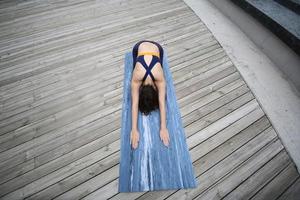 Young attractive woman doing stretching yoga exercise in the park. photo