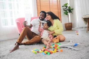 familia multiétnica alegre y su ocio en casa foto