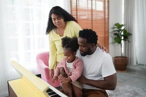 Happy african family having playful time at home,  Family love, Parents and toddler indoor photo