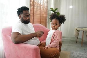 Happy african family having playful time at home,  Family love, Parents and toddler indoor photo