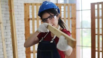 Carpenter grinding joinery product with carvings, finishing woodwork at the carpentry manufacturing photo