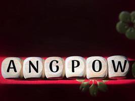 ANGPOW text on wooden cubes background. Chinese new year tradition celebration concept. It means lucky money. photo