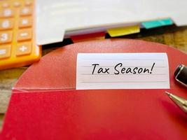 Business Concept - Tax season text written on paper background. Stock photo. photo