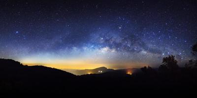 Panorama starry night sky and milky way galaxy with stars and space dust in the universe at Doi inthanon Chiang mai, Thailand photo