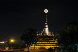 Super moon in night sky and silhouette of ancient pagoda is named Wat Ratchaburana, Phitsanulok in Thailand photo